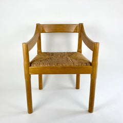 Carimate carver dining chairs by Vico Magistretti