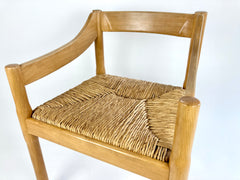 Carimate carver dining chairs by Vico Magistretti
