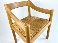 Carimate carver dining chairs by Vico Magistretti